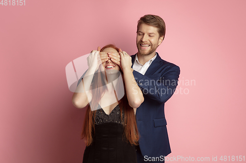 Image of Valentine\'s day celebration, happy caucasian couple isolated on coral background