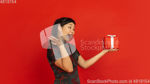 Image of Happy Chinese New Year. Asian young girls\'s portrait isolated on red background