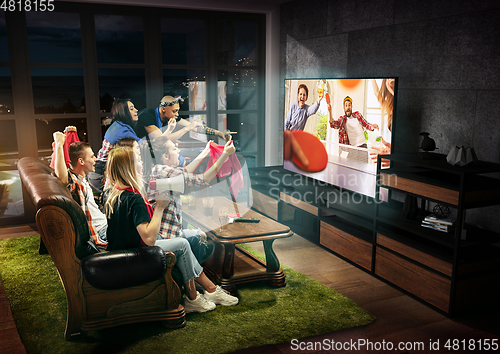 Image of Group of friends watching TV, sport concept, leisure activity