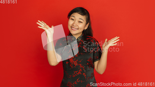 Image of Happy Chinese new year. Asian young girls\'s portrait isolated on red background