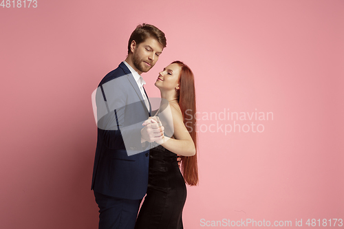 Image of Valentine\'s day celebration, happy caucasian couple isolated on coral background
