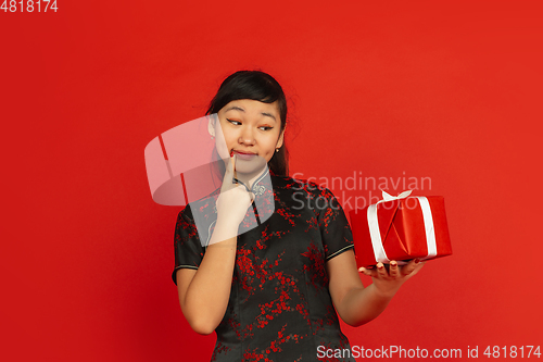 Image of Happy Chinese New Year. Asian young girls\'s portrait isolated on red background