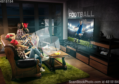 Image of Group of friends watching TV, sport concept, leisure activity