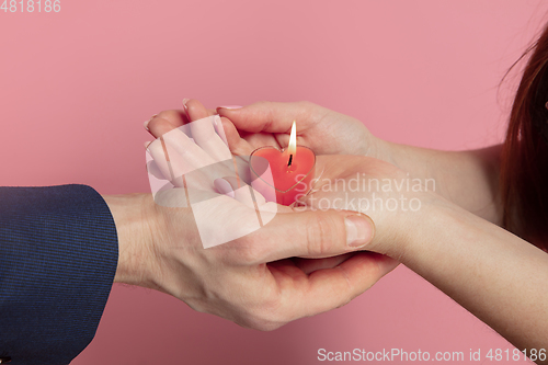 Image of Valentine\'s day celebration, happy caucasian couple isolated on coral background