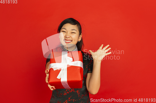 Image of Happy Chinese New Year. Asian young girls\'s portrait isolated on red background