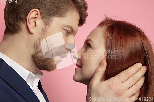 Image of Valentine\'s day celebration, happy caucasian couple isolated on coral background