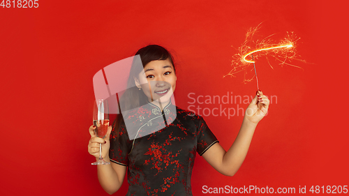 Image of Happy Chinese New Year. Asian young girls\'s portrait isolated on red background