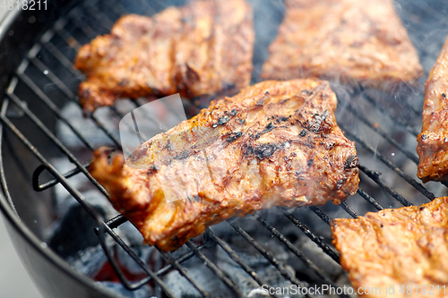 Image of close up of barbecue meat roasting on grill