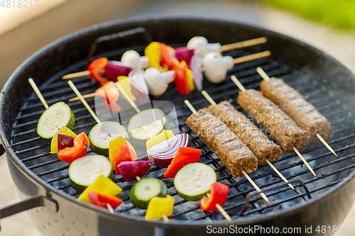 Image of barbecue meat and vegetables roasting on grill