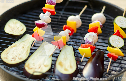 Image of vegetables and mushrooms roasting on brazier grill