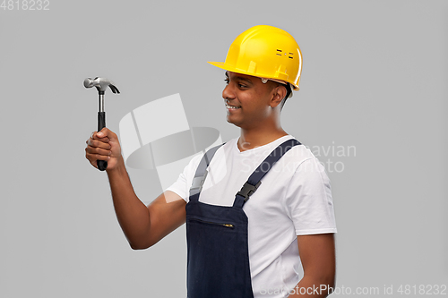 Image of happy smiling indian worker or builder with hammer