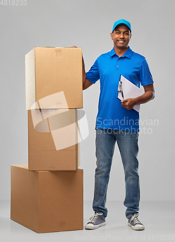 Image of indian delivery man with boxes and clipboard