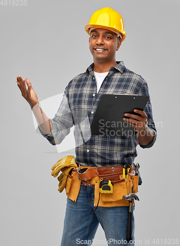 Image of happy indian builder in helmet with clipboard