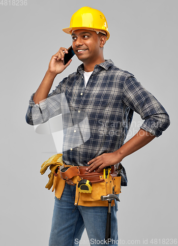 Image of indian builder in helmet calling on smartphone