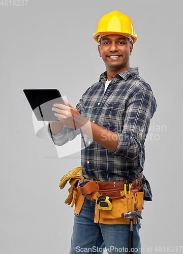 Image of happy indian builder in helmet with tablet pc