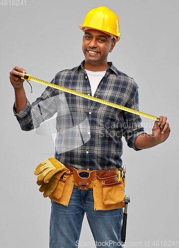 Image of happy indian worker or builder with ruler