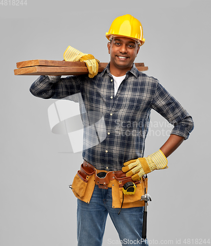 Image of happy indian worker or builder with wooden boards