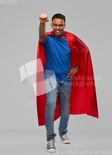 Image of indian man in superhero cape makes winning gesture