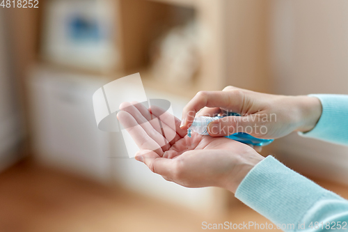 Image of close up of woman spraying hand sanitizer