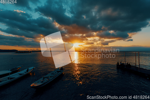 Image of Bali beach with dramatic sky and sunset