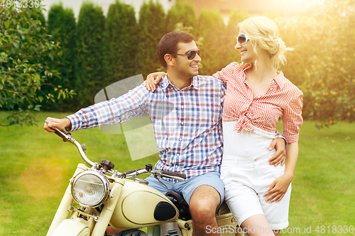 Image of beautiful couple on retro motorbike