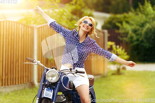 Image of beautiful girl on retro motorbike