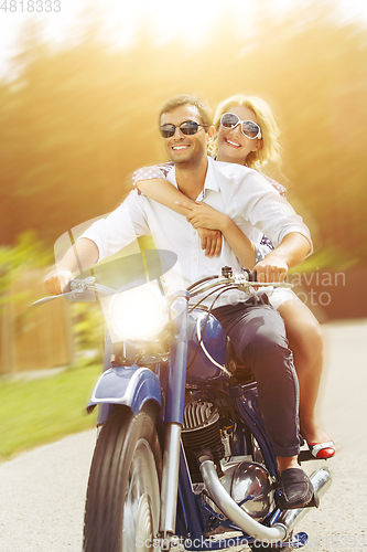 Image of beautiful couple on retro motorbike