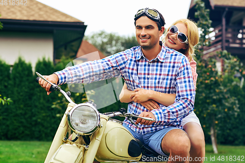 Image of beautiful couple on retro motorbike