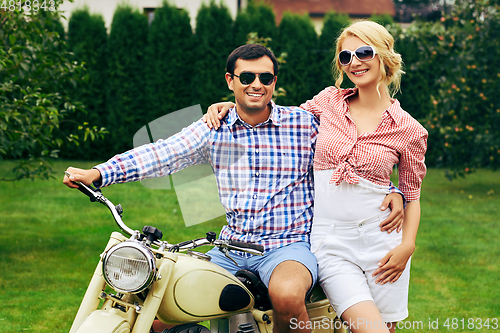 Image of beautiful couple on retro motorbike