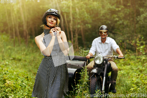 Image of beautiful couple on retro motorbike