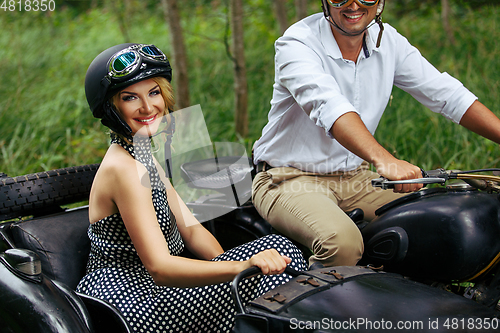 Image of beautiful couple on retro motorbike