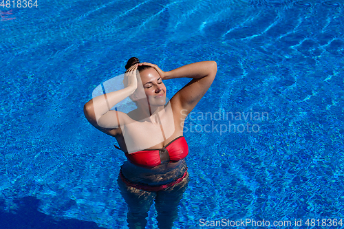 Image of beautiful woman in swimming pool