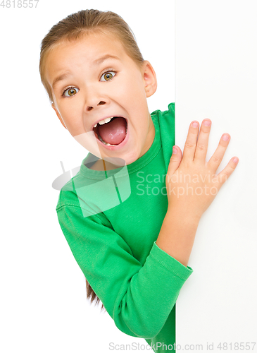 Image of Little girl is looking out from the blank banner