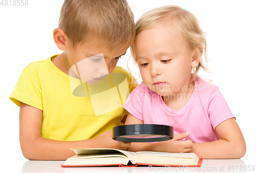 Image of Little girl and boy are reading book