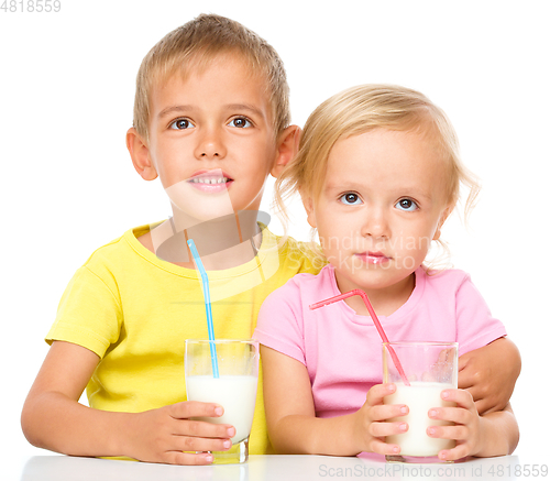 Image of Cute little girl and boy are drinking milk