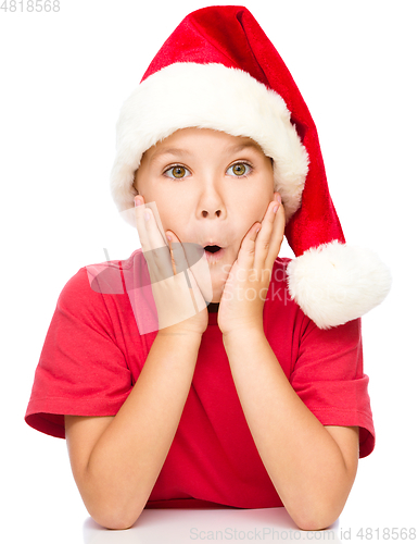 Image of Little girl is holding her face in astonishment