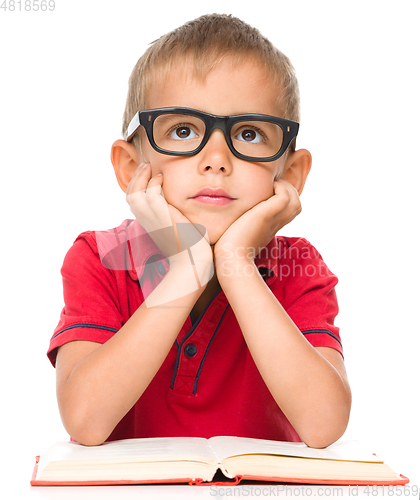Image of Little boy is reading a book