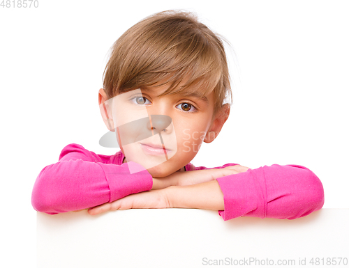 Image of Little girl is looking out from the blank banner