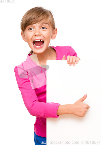 Image of Little girl is looking out from the blank banner