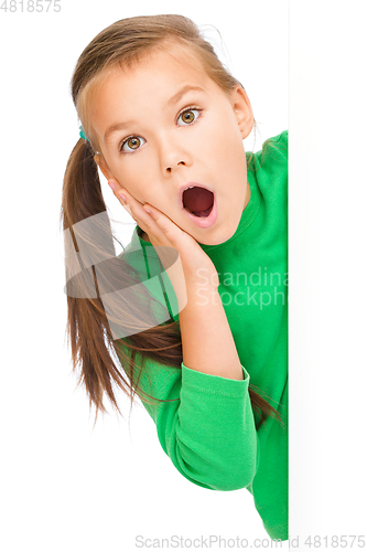 Image of Little girl is looking out from the blank banner