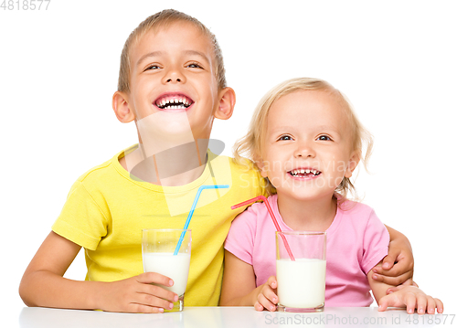 Image of Cute little girl and boy are drinking milk