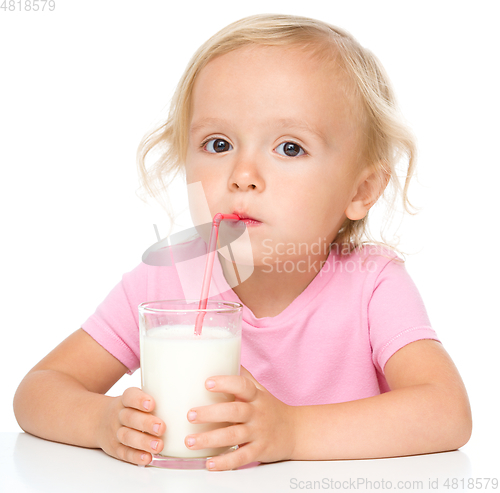 Image of Cute little girl with a glass of milk