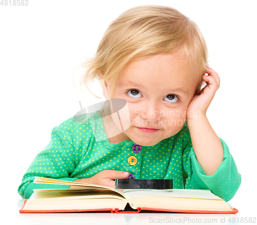 Image of Little girl is reading her book