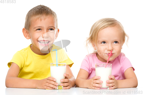 Image of Cute little girl and boy are drinking milk