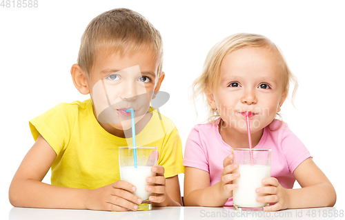 Image of Cute little girl and boy are drinking milk