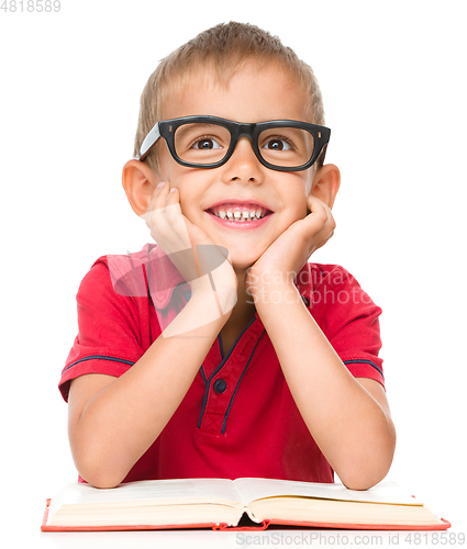 Image of Little boy is reading a book