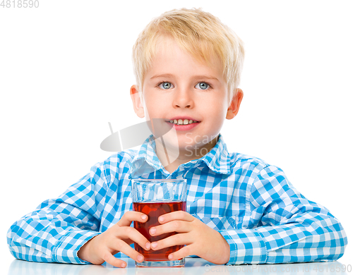 Image of Little boy with glass of cherry juice