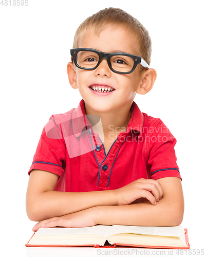 Image of Little boy is reading a book