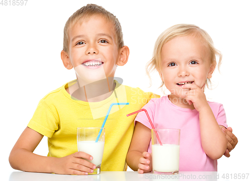 Image of Cute little girl and boy are drinking milk