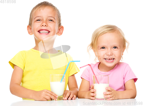 Image of Cute little girl and boy are drinking milk